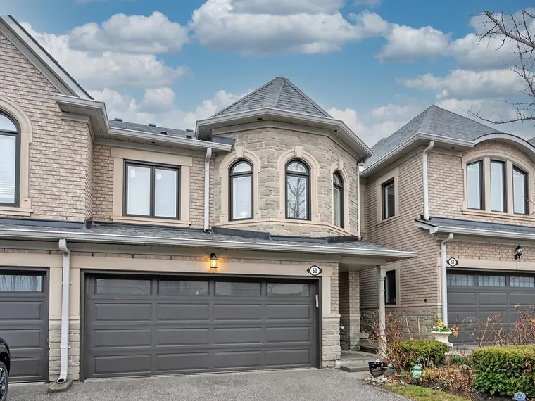 Brick and stone townhome with a turret bay window and a double garage at 60-2250 Rockingham Dr, Oakville, ON